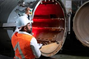 Chief Engineer of the Mechanical Plant Conduct inspection of the sterilization machine tunnel. To check the working condition of the machine to be ready photo