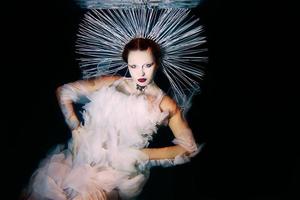 Beautiful woman with red lips and in women's jewellery underwater as the Virgin Mary photo