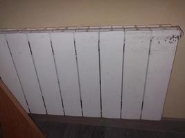 Installed metal heating radiators in the living room in the apartment photo