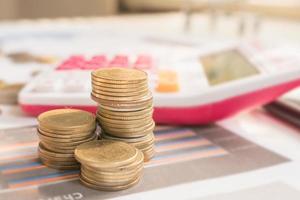Step of coins stacks on financial report with calculator, profit graph of stock market trade indicator financial. photo