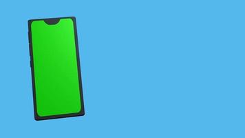 3D-Smartphone mit grünem Bildschirm zum Einfügen, auf blauem, leerem Hintergrund. Das Telefon erscheint in einem der Teile des Bildschirms und dreht sich langsam. video