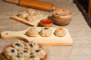 Chinese steamed dimsum or dim sum, on wooden plate, traditional cuisine photo