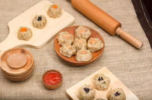 Dim sum or dimsum flatlay photo with wooden plate