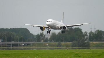 AMSTERDAM, THE NETHERLANDS JULY 27, 2017 - Vueling Airbus 320 EC LOP, landing on runway 18R Polderbaan. Kestrel bird near runway. Shiphol Airport, Amsterdam, Holland video