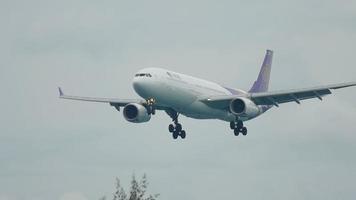 PHUKET, THAILAND DECEMBER 2, 2016 - Thai Airways Airbus 330 HS TER approaching before landing at Phuket International airport, slow motion video