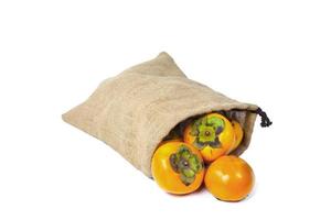 Persimmon in sack isolated on white background photo