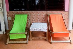 Green orange beach chairs at balcony photo