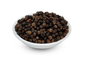 Black pepper pile or Black peppercorns seeds in ceramic bowl isolated on white background ,include clipping path photo