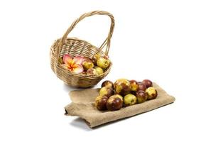 Chinese jujube in wicker baskets isolated on white background photo