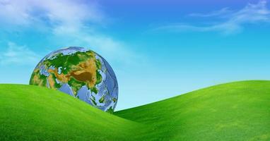 Earth globe in green grass conceptual photo