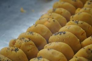 yellow colored peda sweets image photo