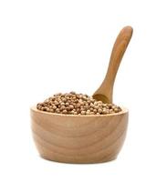 dried coriander seeds with bowl and wooden spoon isolated on white background photo