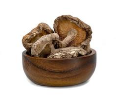 dry shiitake mushrooms with wooden bowl isolated on white background photo
