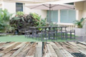 Top desk with blur outdoor restaurant background,wooden table photo