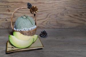 melon sliced on wooden background photo