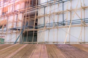 Top desk with blur scaffolding bamboo background,wooden table photo