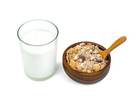 milk in transparent glass and muesli multi fruit in wooden bowl and spoon isolated on white background ,include clipping path photo