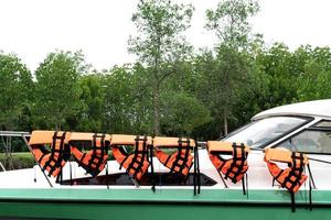 black orange life jacket on stainless steel line photo