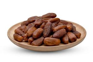 dry dates palm in wooden bowl isolated on white background ,include clipping path photo