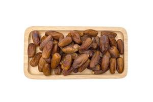 dry dates palm in wooden bowl isolated on white background ,include clipping path photo