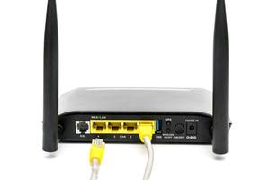 Black wireless router with local area network cable isolated on white background photo