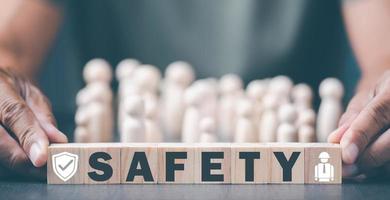 Engineers hold a wooden block on a table, demonstrating safe operation, maintenance, health care, equipment and equipment inspection, to prevent potential hazards. photo