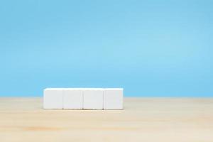 White wooden cube on table with copy space for text or icon photo