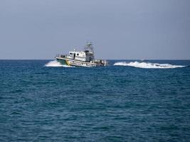 CALAHONDA, ANDALUCIA, SPAIN - MAY 6. Guardia Civil boat powering through the sea near Calahonda Spain on May 6, 2014 photo