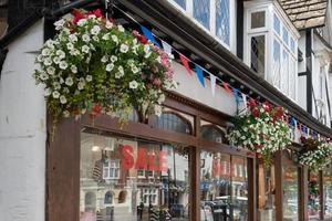 East Grinstead, West Sussex, UK, 2014. Hanging baskets outside a shop in East Grinstead photo