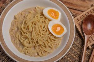 Udon and egg Japanese food with chopsticks and copy space photo
