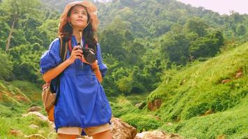 Young woman backpacker enjoy the view at mountain photo