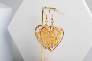Heart-shaped earrings made of resin, handmade jewelry. photo