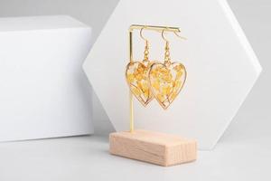 Heart-shaped earrings made of resin, handmade jewelry. photo