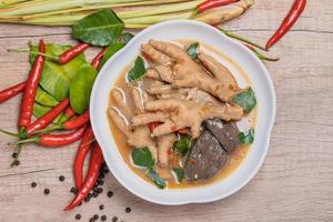 Spicy Stewed Chicken Feet Tom Yum with Fresh Chili, Lemongrass, Kaffir Lime Leaves photo