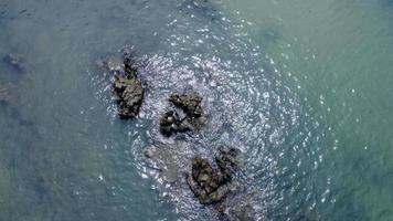 Beautiful aerial view of the island coastline in Phang Nga Bay of the Andaman Sea, surrounded by pine trees and small rocks. video