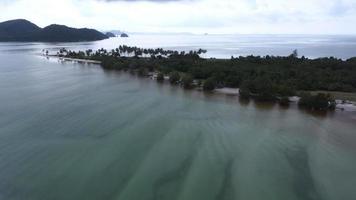 Beautiful aerial view of the sandy beach jutting out to the sea with lush tropical trees and soft blue ocean waves at Laem Haad Beach, famous tourist attraction of Koh Yao Yai, Phang Nga, Thailand. video