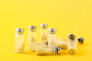 Bubbles, ampoules with dry probiotic, bifidobacteria, with probiotic powder inside on a yellow background. Copy space. photo