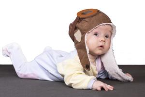 Baby aviator, wearing a pilot hat, close up portrait. photo