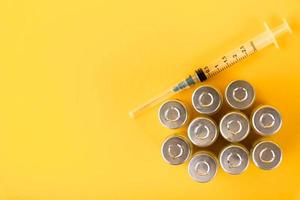 Bubbles, ampoules with dry probiotic, bifidobacteria, on a yellow background. Copy space. photo