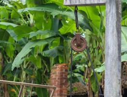 Water well rope drive wheel blur bokeh photo