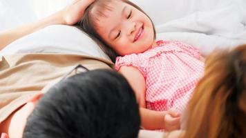 Happy family with mother, father and disabled daughter spending time together at home. photo