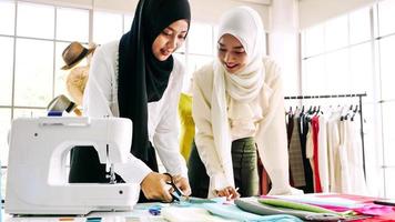 Beautiful muslim women working together at the clothing office. photo