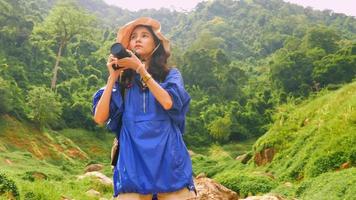 Young woman backpacker enjoy the view at mountain photo