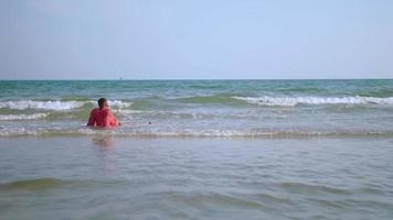 African businessman relaxing on the beach during the weekend. photo