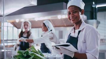 Group of schoolgirls having fun learning to cook. Female students in a cooking class. photo