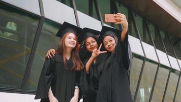 Group of friends having fun celebrating their graduation by taking pictures together. photo