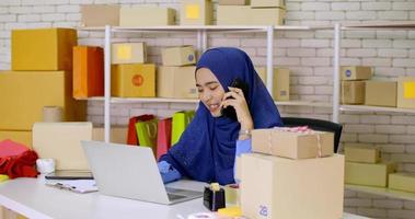 Beautiful muslim female merchandiser talking with buyer at the office. photo