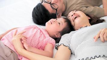 Happy family with mother, father and disabled daughter spending time together at home photo