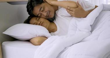 Happy asian lover sleeping together in a bedroom. photo