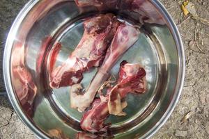 raw mutton bones for cooking soup in a pot in nature photo